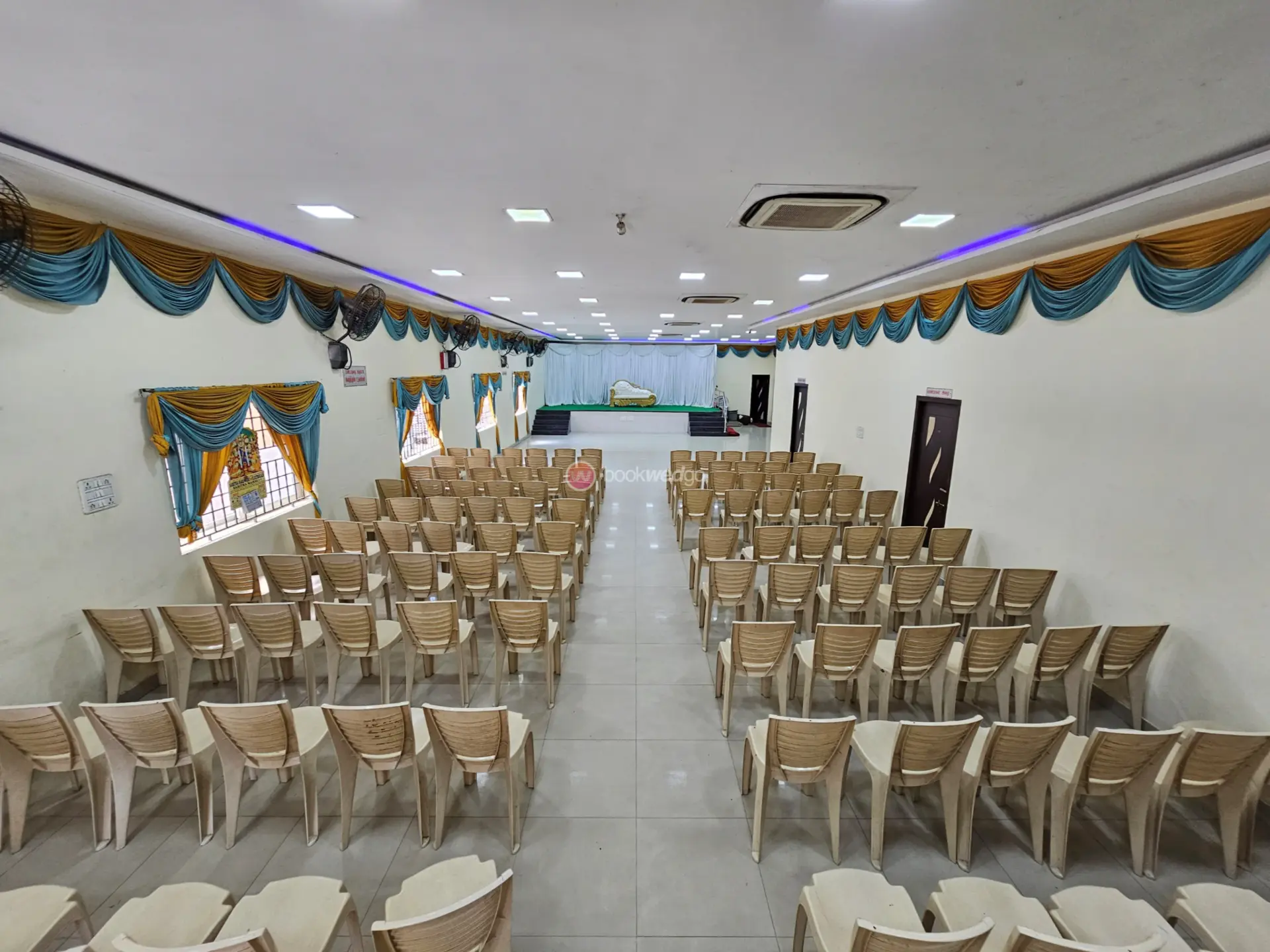 Elegant South Indian wedding hall with marigold garlands and floral arch