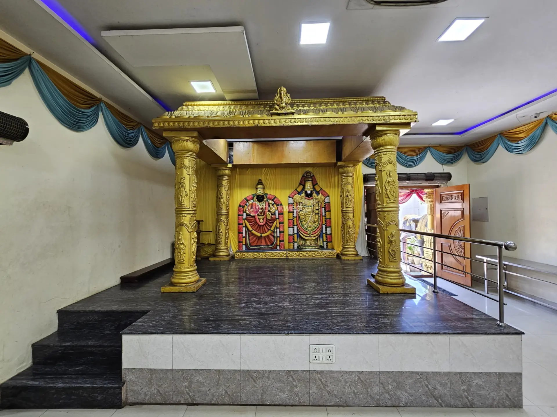 Traditional South Indian betrothal ceremony with floral and brass decorations